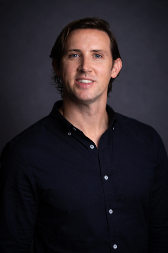 Professional headshot of smiling man